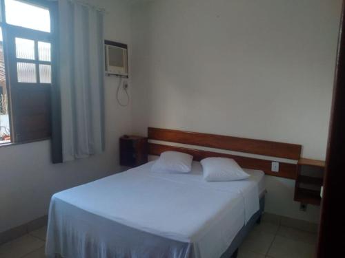 En eller flere senge i et værelse på Pousada Sol & Mar