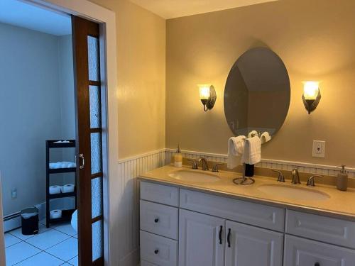 un bagno con due lavandini e un grande specchio di Spacious 5 BR Home w/ Hot Tub a North East