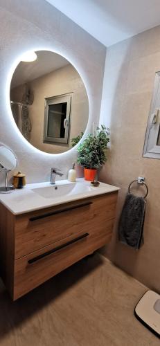a bathroom with a sink and a mirror at ¡ VAMOS A LA PLAYA ! in Carboneras