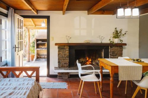 een woonkamer met een tafel en een open haard bij Solar de amigos in Tandil