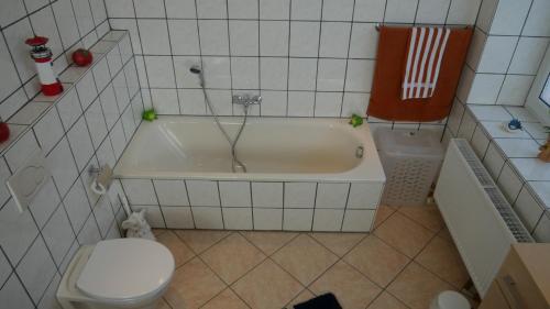 a bathroom with a white tub and a toilet at FeWo Lienen in Lienen