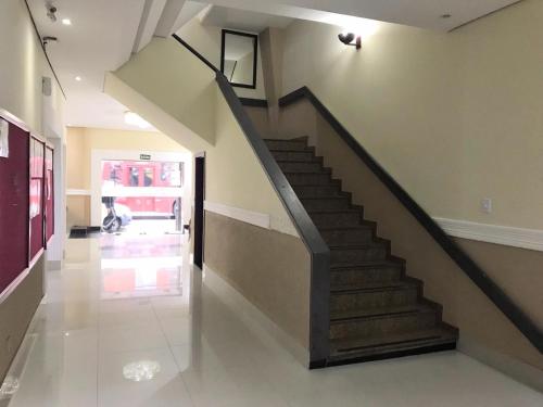 a hallway with a staircase in a house at Hotel Estação Express in Curitiba