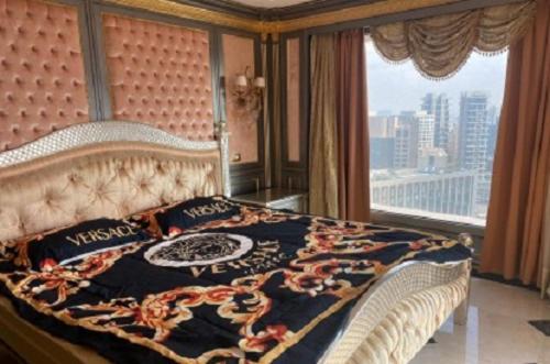 - une chambre avec un grand lit et une grande fenêtre dans l'établissement הסוויטה המלכותית ברמת גן, à Tel Aviv
