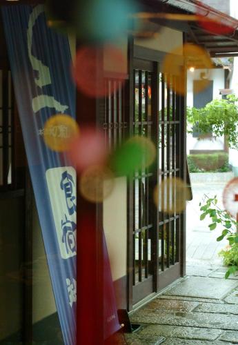 a glass door of a building with a sign on it at Taikyourou in Miyazu