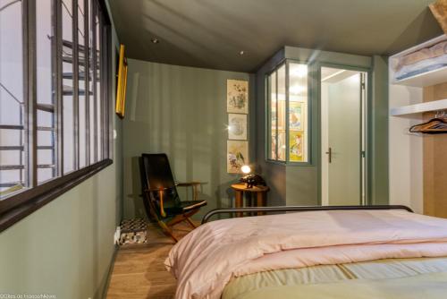 a bedroom with a bed and a window at Au Noeud Vert Chambres d'hôtes in Nevers