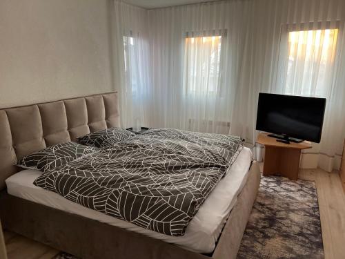 a bedroom with a bed and a flat screen tv at Old town,Kovaci 2 in Sarajevo