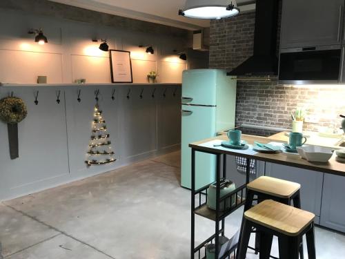 a kitchen with a blue refrigerator and a christmas tree at Morriña Atlantica Loft in Pontevedra