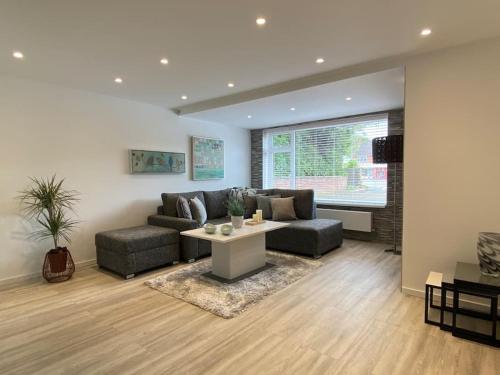a living room with a couch and a table at Msquared Villa, Modern 3-Bedroom House, 3 Parking Spaces in Kidlington
