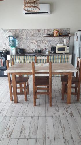 a wooden table and chairs in a kitchen at Rincón Joven II in San Miguel del Monte