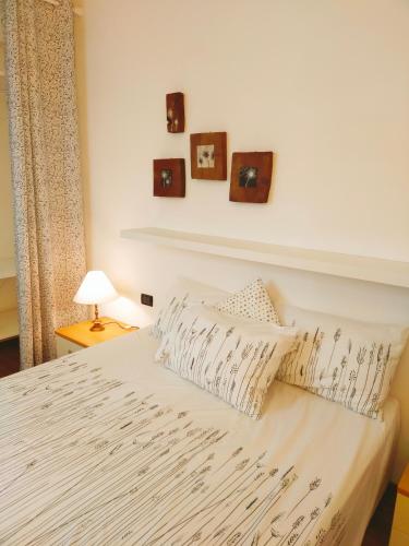 a bedroom with a white bed with two pillows at La Casina di Borgo in Borgo San Lorenzo