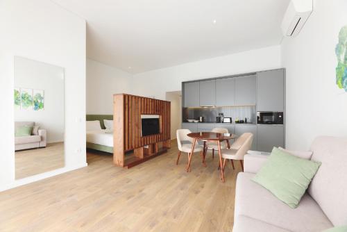 a living room with a couch and a table at RIBEIRA FLORES 59 Downtown Apartments in Porto