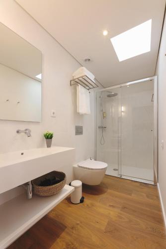 a bathroom with a toilet and a sink and a shower at RIBEIRA FLORES 59 Downtown Apartments in Porto