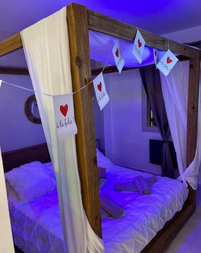 a bedroom with a bed with cards hanging on a string at Appartement - Spa in Monteux