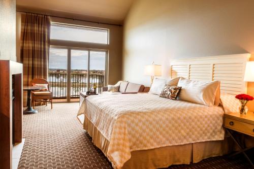 a hotel room with a bed and a balcony at The Lodge at Columbia Point in Richland