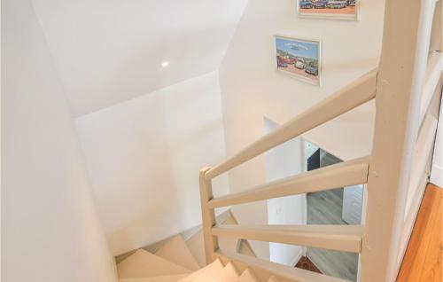 a staircase in a house with white walls and wooden floors at Nice Home In Saint-Aubin-Sur-Mer in Saint-Aubin-sur-Mer