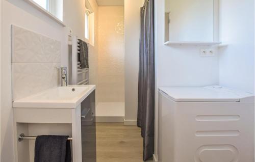 a white bathroom with a sink and a mirror at Nice Home In Saint-Aubin-Sur-Mer in Saint-Aubin-sur-Mer