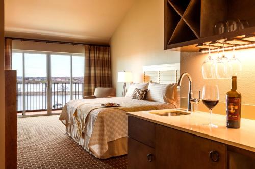 a hotel room with a bed with a window and a sink at The Lodge at Columbia Point in Richland
