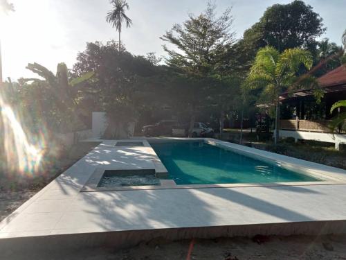 a swimming pool in the backyard of a house at Baan Banyan Villa, wood house short walk to Mae Nam beach in Mae Nam
