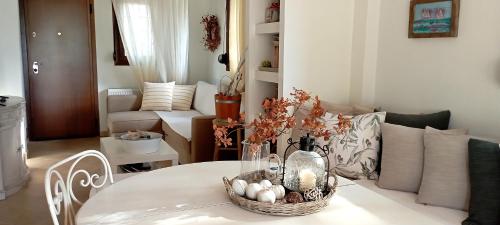 a living room with a table with a basket of eggs at High aesthetics maisonette in the wood by the sea in Metamorfosi