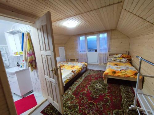 a small room with two beds and a bathroom at Гостинний двір Матійчуків Новий in Vorokhta