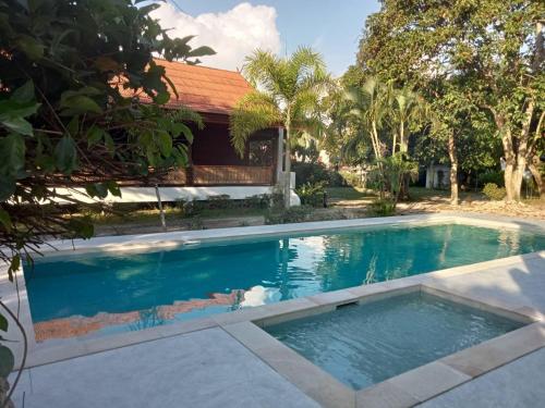 a swimming pool in front of a house at Baan Khun Nang Colonial Residence in Mae Nam