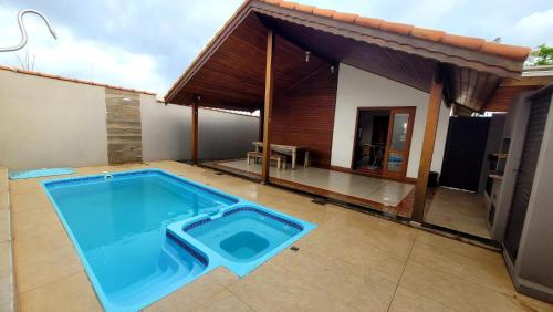 a swimming pool in front of a house at Casa em Brotas com Piscina e Churrasqueira in Brotas
