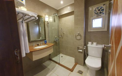 a bathroom with a toilet and a sink and a shower at Kemet Boutique Hotel in Cairo