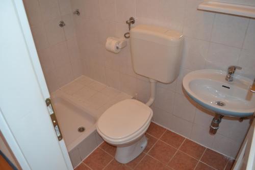 a bathroom with a toilet and a sink at Apartment Bešlić in Makarska