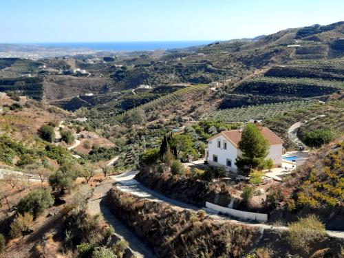 a house on a hill with a winding road at Casa Montaña Vélez-Málaga B&B in Vélez-Málaga