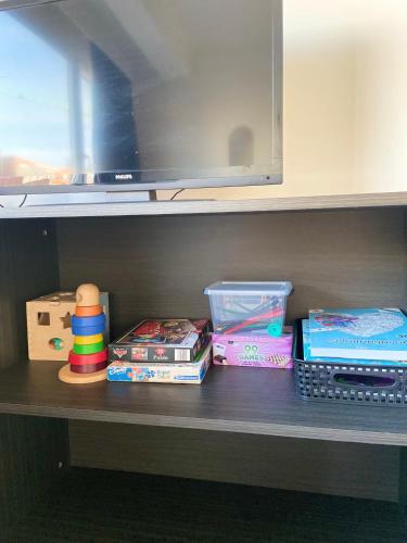 a shelf with toys and other items on it at Studio Delfien in Oostduinkerke