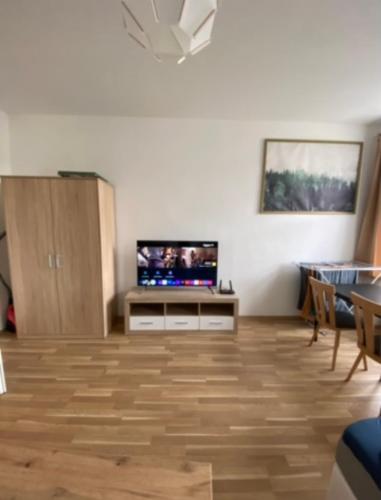 a living room with a flat screen tv and a table at Nice apartment Hollergasse 22 in Vienna