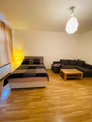 a bedroom with a bed and a couch at Nice apartment Hollergasse 22 in Vienna