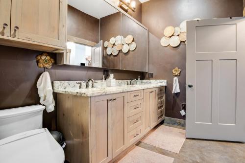 a bathroom with a sink and a toilet and a mirror at West Side Nest in Fredericksburg