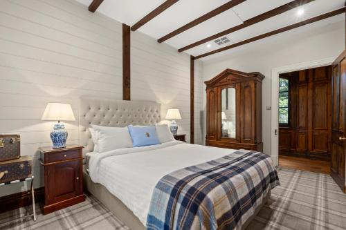 a bedroom with a bed and a table and lamps at Carriage House 1884 in Crafers
