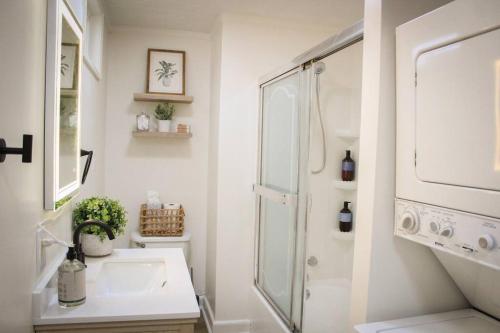 a white bathroom with a sink and a shower at New 1-bedroom Bungalow! 4 miles to CLE in Berea