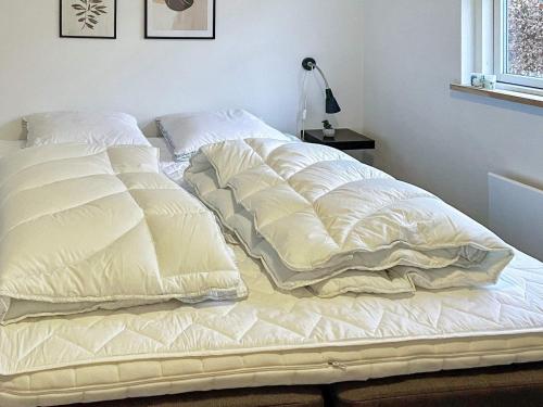 a large white bed sitting in a bedroom at 8 person holiday home in Silkeborg-By Traum in Silkeborg