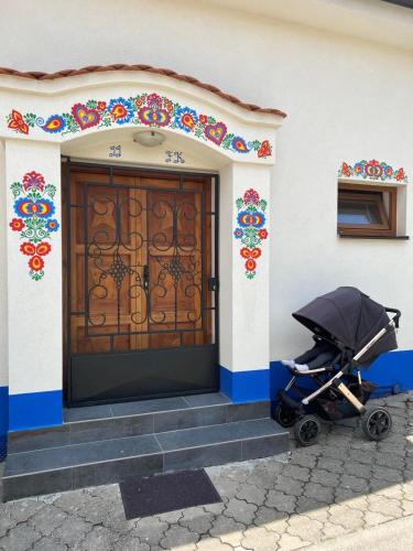 a stroller parked in front of a building with a door at Vinný sklípek U Františka in Dolní Bojanovice