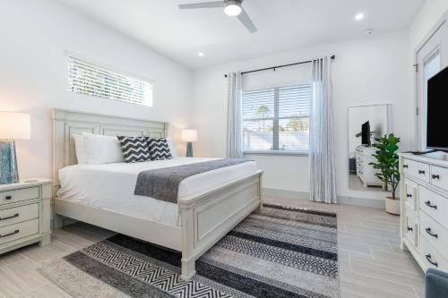a white bedroom with a bed and a window at Potomac Escape - Unit B in Palm Coast