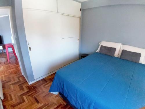 a bedroom with a blue bed in a room at Apartamento Nueva Córdoba in Cordoba