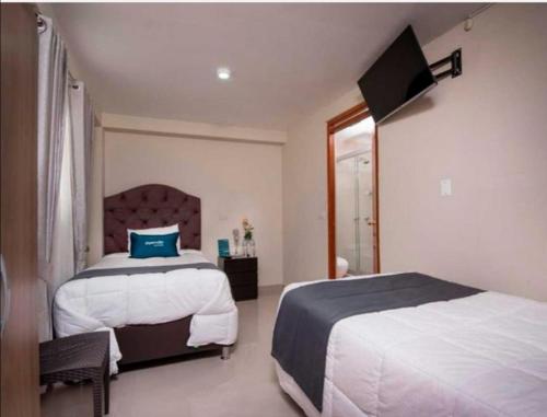 Postel nebo postele na pokoji v ubytování Hotel Luna de Oro Cusco