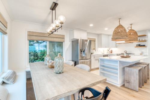 a kitchen with a large wooden table in a room at The Crew House in Tillamook