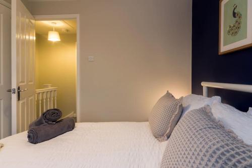 a bedroom with a white bed with two pillows at Stylish two bedroom home SHEFFIELD in Sheffield