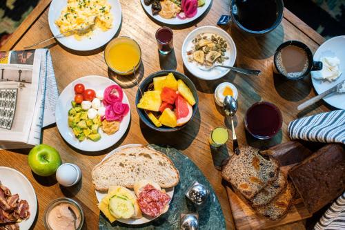 a wooden table with plates of food on it at Best Western and hotel in Stockholm