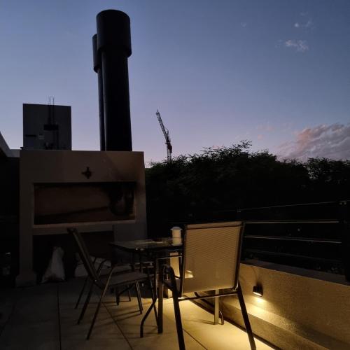 a patio with a table and chairs on a balcony at EXCLUSIVO PENTHOUSE EN CORDON SOHO CON DISNEY PLUS y PARKING INCLUIDOS in Montevideo