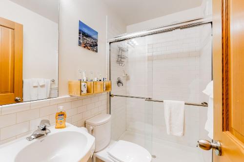 a bathroom with a toilet and a sink and a shower at Westside Zen in Seattle