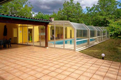 a large glass house with a swimming pool at Zen Vouga in Ribeiradio