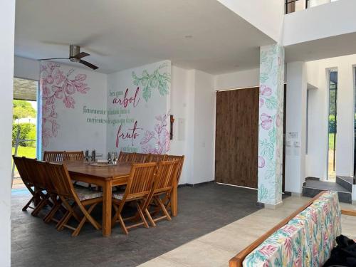a dining room with a wooden table and chairs at La Higuera, Casa Campestre. in El Asilo
