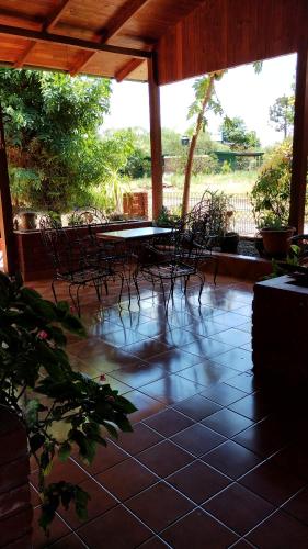 a patio with chairs and tables on a tiled floor at Revivir "LA CASA DE LOS ABUELOS" in Montecarlo
