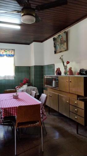 a kitchen with a table with a pink table cloth at Revivir "LA CASA DE LOS ABUELOS" in Montecarlo