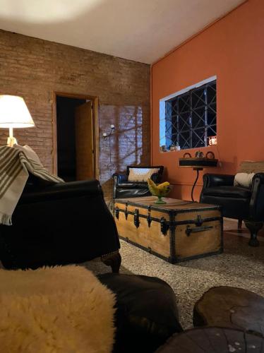 a living room with a couch and a table at Inti, hospedaje de campo. in Bartolomé Mitre